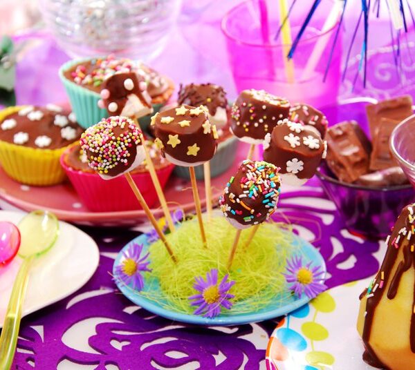 colorful decoration of birthday party table with homemade  sweets for child